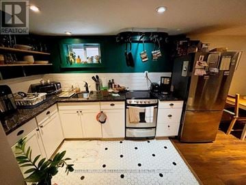 Toronto (Danforth Village-East York) apartment for rent - A kitchen with white cabinets and a black counter top.