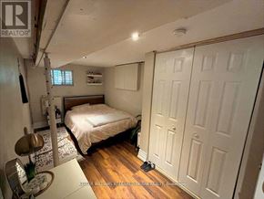 Toronto (Danforth Village-East York) apartment for rent - A bedroom with a bed, a chair, and a table.
