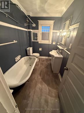 Welland (Welland Downtown) multi-family for rent - A bathroom with a white tub and a toilet.