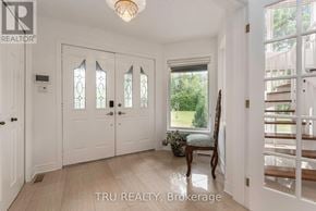 Ottawa apartment for rent - A white door with a glass window is in the middle of a hallway.