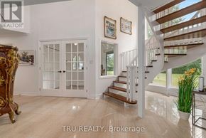Ottawa apartment for rent - A white room with a wooden staircase and a glass door.