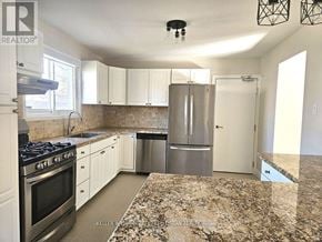Pickering (West Shore) apartment for rent - A kitchen with granite countertops and stainless steel appliances.