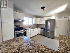 Pickering (West Shore) apartment for rent - A kitchen with granite countertops and stainless steel appliances.