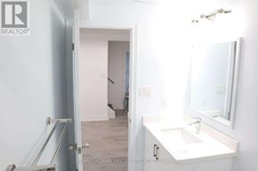 Pickering (Brock Ridge) apartment for rent - A bathroom with a sink, mirror and a door.