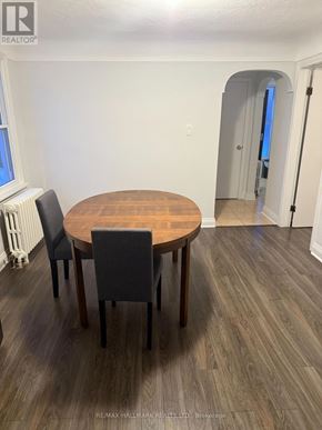 St. Catharines (Downtown) duplex for rent - A dining room with a round wooden table and chairs.