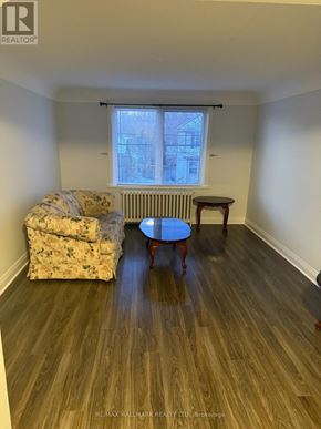 St. Catharines (Downtown) duplex for rent - A room with a couch, chair, and table in it.