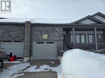 North Perth (Elma) townhouse for rent - A house with a snow pile in front of it.
