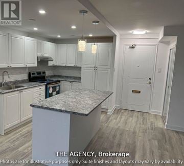 Toronto (Westminster-Branson) house for rent - A kitchen with white cabinets and a marble island.