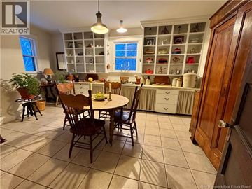 Moncton apartment for rent - A kitchen with a table and chairs in the middle of the room.
