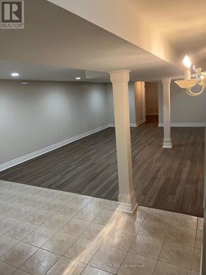Toronto (Newtonbrook East) apartment for rent - A room with a wooden floor and a chandelier.