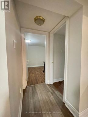 Toronto (Newtonbrook East) apartment for rent - A hallway with wood flooring and white walls.