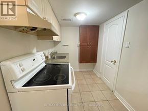 Toronto (Newtonbrook East) apartment for rent - A small kitchen with a white stove and a white oven.