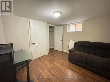 Toronto (Newtonbrook East) apartment for rent - A living room with a couch and a television.