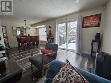 Kitchener townhouse for rent - A living room with a dining table and chairs.