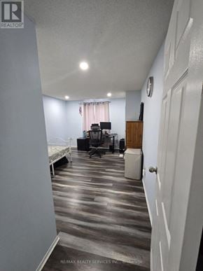 Kitchener townhouse for rent - A room with a bed, desk, and chair.