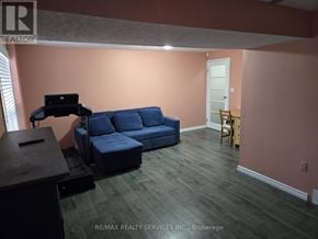 Kitchener townhouse for rent - A living room with a blue couch and a wooden table.