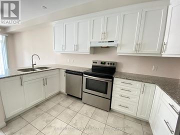 Hamilton (Meadowlands) townhouse for rent - A kitchen with white cabinets and a granite countertop.