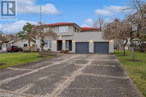 Fort Erie (Central) apartment for rent - A house with a red roof and a driveway in front.