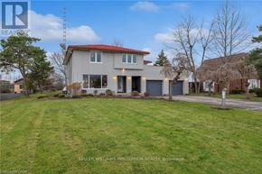 Fort Erie (Central) apartment for rent - A house with a red roof and a well-maintained lawn in front.