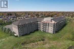 Kingston (South Of Taylor-Kidd Blvd) condo for rent - A large building with the words RE/MAX RISE EXECUTIVES, BROKERAGE on it.