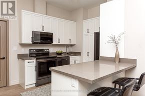Kingston (South Of Taylor-Kidd Blvd) condo for rent - A kitchen with white cabinets and a large island.