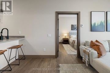 Kingston (City Northwest) condo for rent - A living room with a white couch and a painting on the wall.
