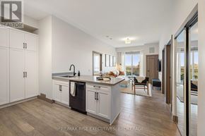 Kingston (City Northwest) condo for rent - A kitchen with white cabinets and a wooden floor.