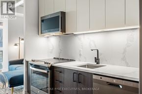 Ottawa condo for rent - A modern kitchen with a sink, stove, and oven.