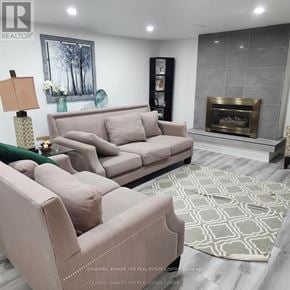 Barrie (Grove East) apartment for rent - A living room with a fireplace and a couch.