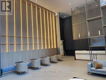 Mississauga (Creditview) condo for rent - A modern living room with a blue sofa and a wooden wall panel.
