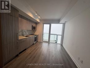 Mississauga (Creditview) condo for rent - A spacious kitchen with wooden cabinets and a large window.