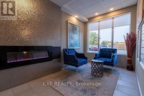 Niagara Falls (Arad/Fallsview) multi-family for rent - A living room with a fireplace and blue chairs.