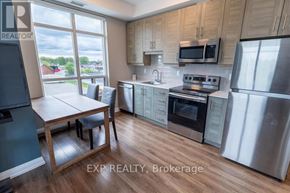 Niagara Falls (Arad/Fallsview) multi-family for rent - A kitchen with wooden cabinets and stainless steel appliances.