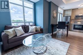 Niagara Falls (Arad/Fallsview) multi-family for rent - A living room with a grey couch and a glass coffee table.