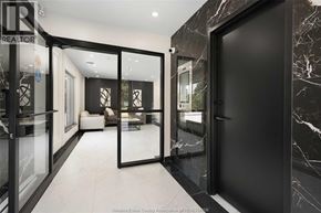 Windsor condo for rent - A black and white marble hallway with a glass door.