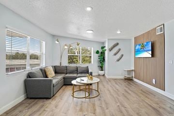 Miami apartment for rent - A living room with a grey sofa and a coffee table.