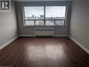 Hamilton condo for rent - A room with a window and a radiator on the floor.