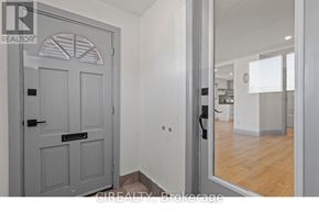 St. Catharines (E. Chester) apartment for rent - A grey door with a black handle is in a room with white walls.