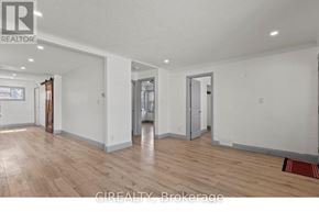 St. Catharines (E. Chester) apartment for rent - A large empty room with wooden floors and white walls.