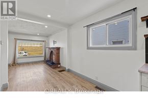 St. Catharines (E. Chester) apartment for rent - A room with a fireplace and a window with blinds.