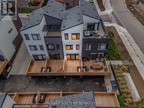 Mississauga (Port Credit) townhouse for rent - A Vanguard Realty Brokerage Corp. sign is on a building.