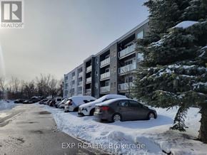 Orillia townhouse for rent - A car is parked in front of a building with snow on the ground.