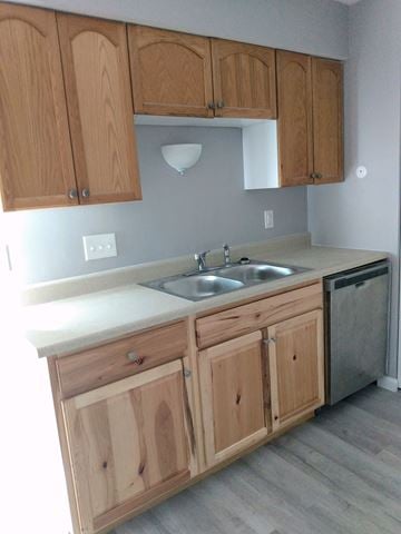 Shiloh apartment for rent - A kitchen with wooden cabinets and a white countertop.