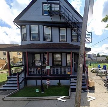 Cleveland apartment for rent - A grey house with a red and white striped awning.