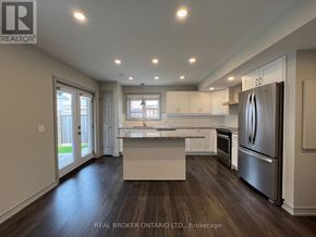 Whitchurch-Stouffville (Stouffville) apartment for rent - A kitchen with a granite countertop and wooden floors.