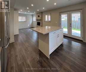 Whitchurch-Stouffville (Stouffville) apartment for rent - A stone fireplace in a room with wood flooring and a window.