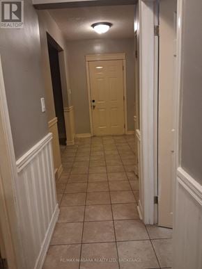 Niagara Falls (Downtown) apartment for rent - A hallway with a door at the end.