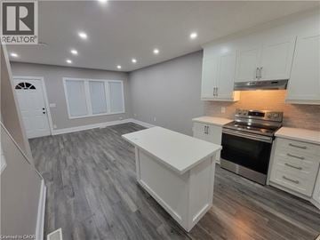 Hamilton apartment for rent - A kitchen with white cabinets and a wooden floor.