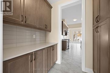 Oro-Medonte apartment for rent - A kitchen with wooden cabinets and a white countertop.