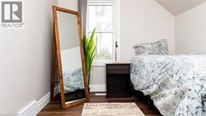 Stratford apartment for rent - A bedroom with a bed, a dresser, and a mirror.